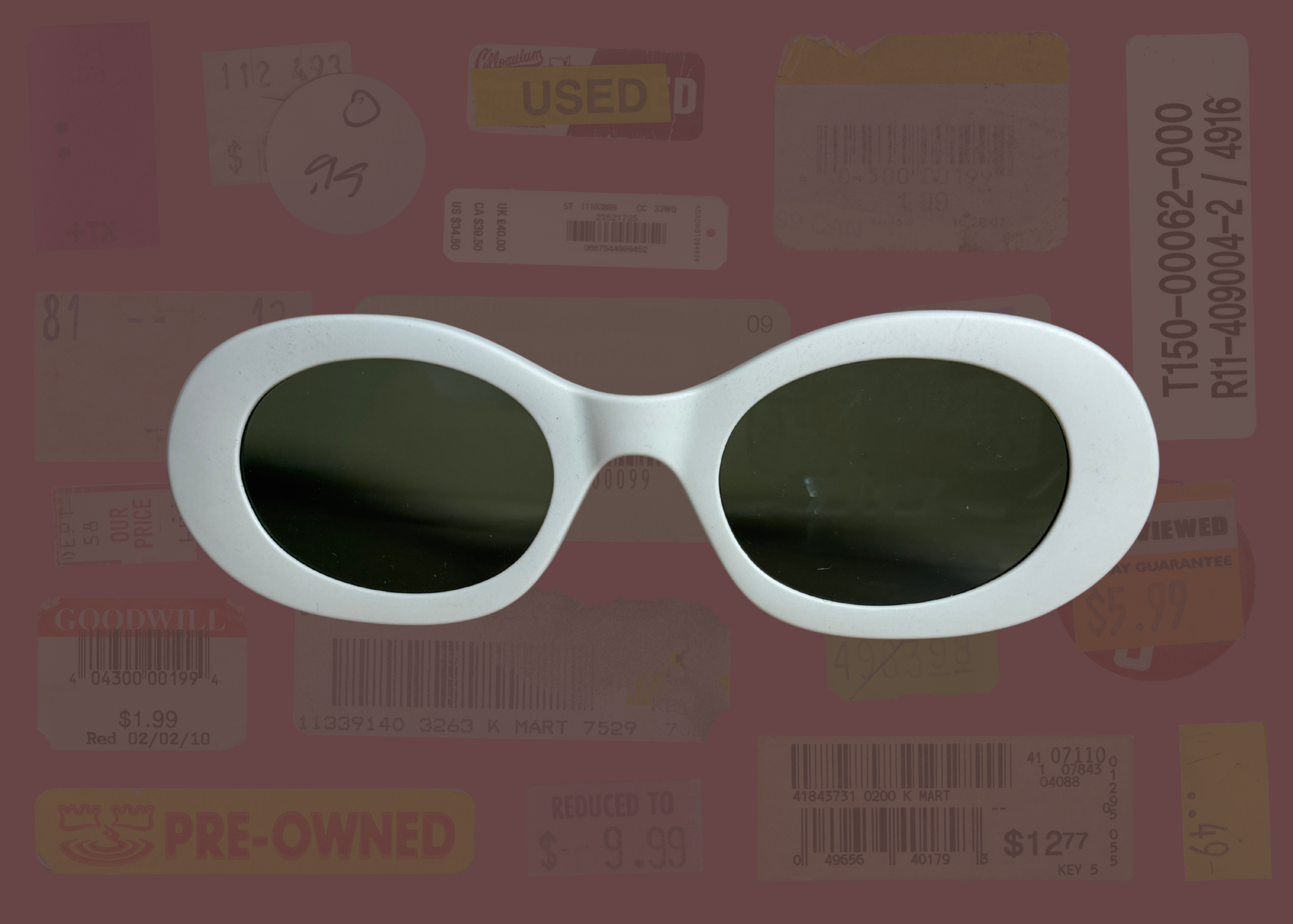 White oval sunglasses with dark lenses on a background with various text and logos
